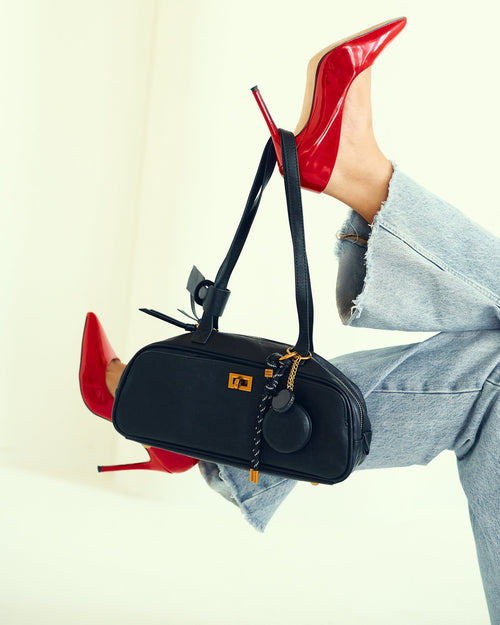 Amber Bag in Black with red heels, styled by Joie